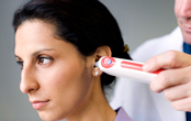woman having her temperature read by a doctor