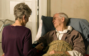 woman assisting an elderly man