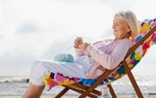 woman relaxing in a chair on the beach