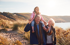 grandparents walking with grandchild