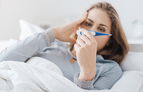 woman viewing thermometer