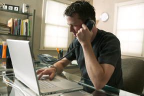 man working on a computer from home