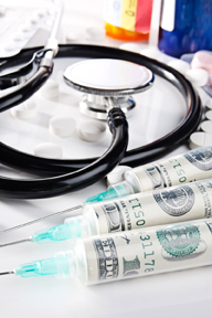 close up of money inside syringes