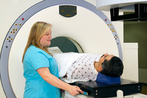 aid helping a person getting a cat scan